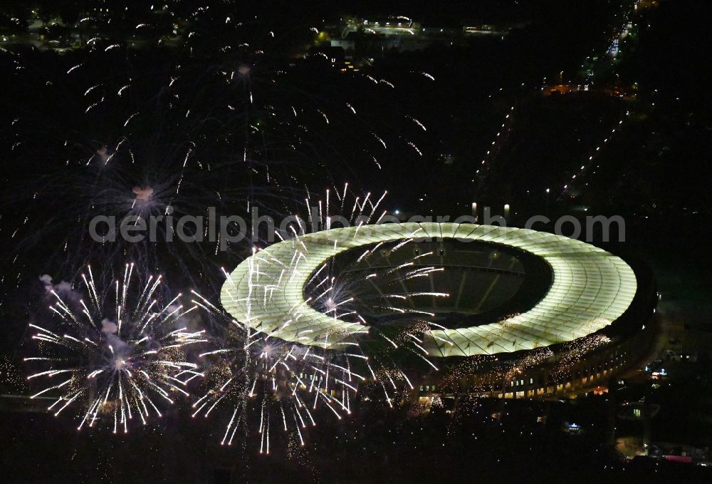 Aerial photograph at night Berlin - Night lighting Fireworks figures in the night sky above the event grounds of Pyronale Fireworks Competition at the Olympic Stadium in the district Charlottenburg in Berlin, Germany