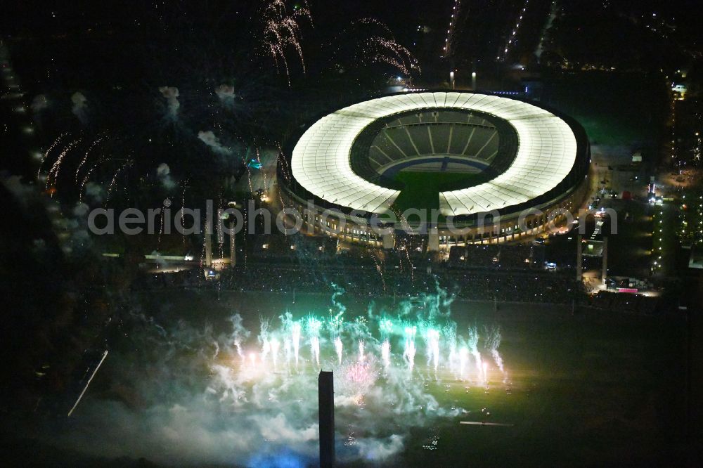 Berlin at night from above - Night lighting Fireworks figures in the night sky above the event grounds of Pyronale Fireworks Competition at the Olympic Stadium in the district Charlottenburg in Berlin, Germany