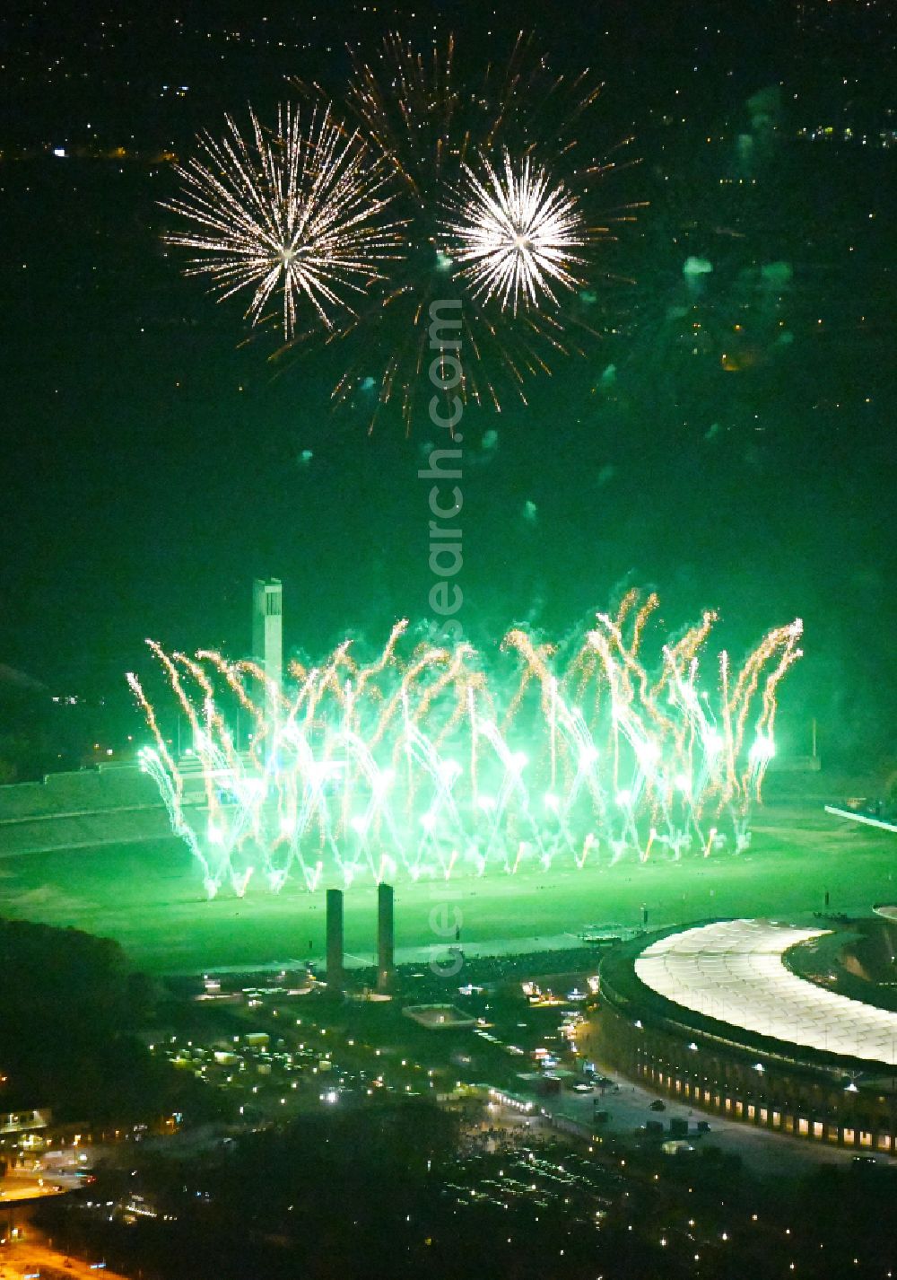 Aerial photograph at night Berlin - Night lighting Fireworks figures in the night sky above the event grounds of Pyronale Fireworks Competition at the Olympic Stadium in the district Charlottenburg in Berlin, Germany