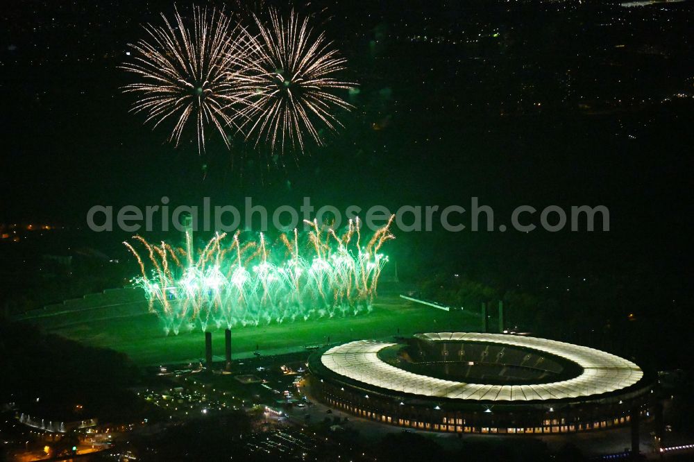 Aerial image at night Berlin - Night lighting Fireworks figures in the night sky above the event grounds of Pyronale Fireworks Competition at the Olympic Stadium in the district Charlottenburg in Berlin, Germany