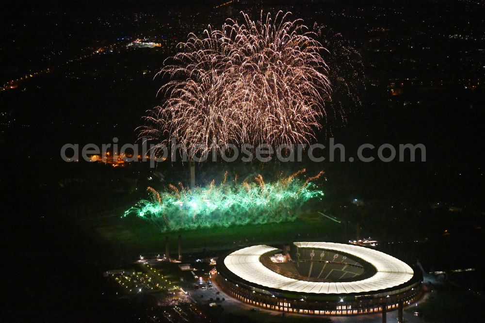Berlin at night from above - Night lighting Fireworks figures in the night sky above the event grounds of Pyronale Fireworks Competition at the Olympic Stadium in the district Charlottenburg in Berlin, Germany