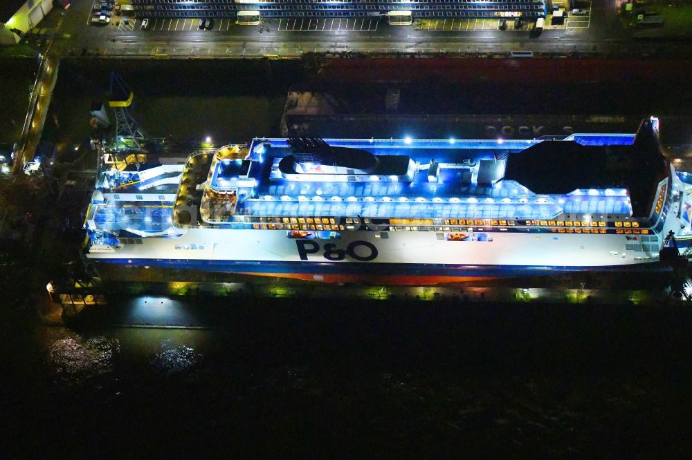 Hamburg at night from the bird perspective: Night lighting ferry ship SPIRIT OF FRANCE on Shipyard on the elbe banks in Hamburg, Germany
