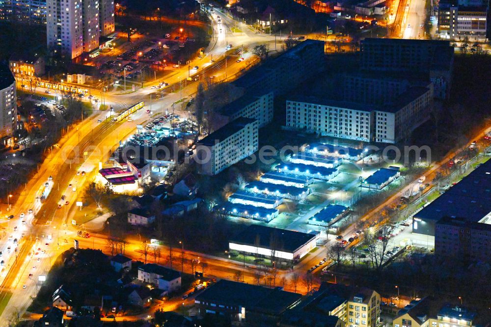 Aerial photograph at night Berlin - Night lighting container settlement as temporary shelter and reception center for refugees on Wollenberger Strasse in the district Hohenschoenhausen in Berlin, Germany