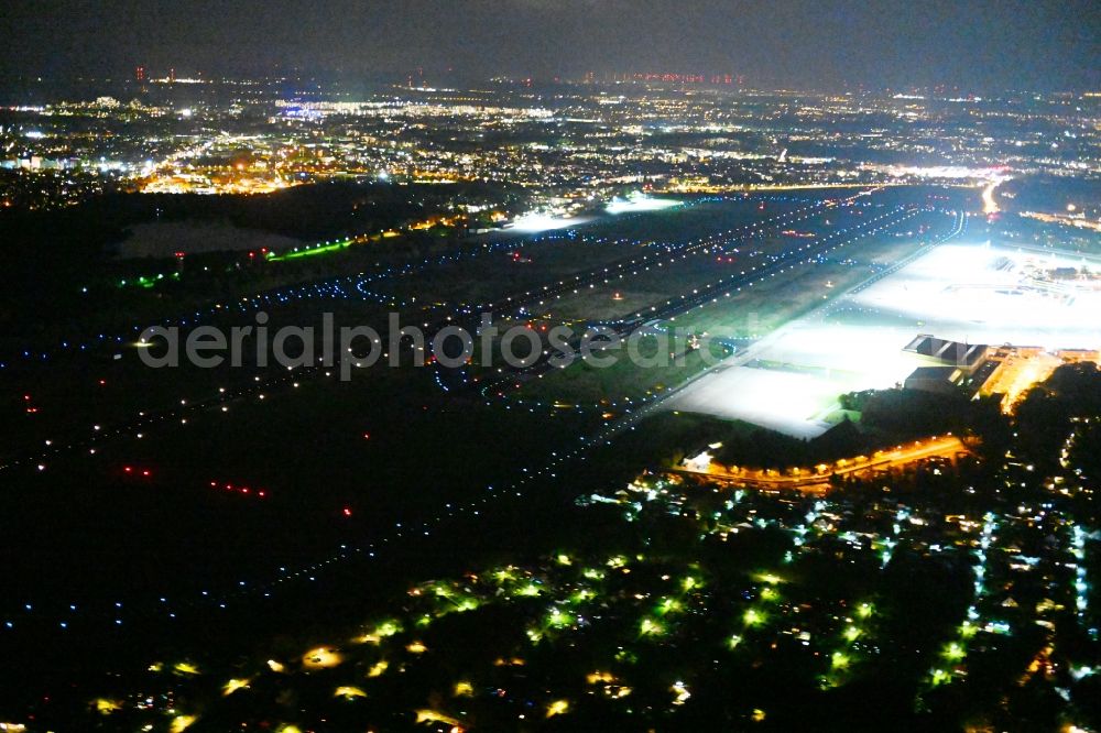 Aerial photograph at night Berlin - Night lighting flight operations at the terminal of the airport Berlin - Tegel