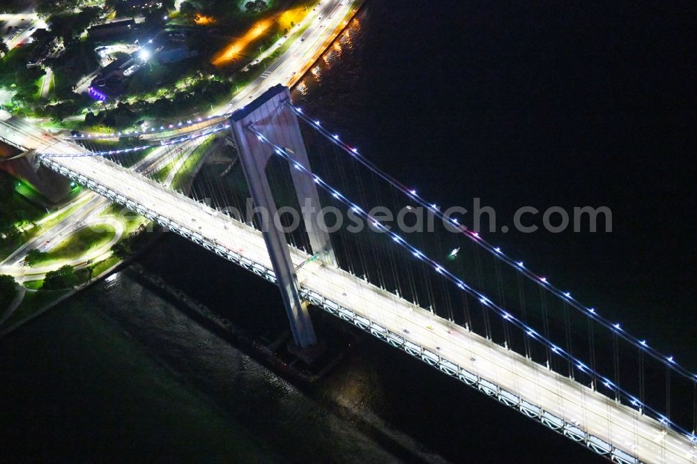 Aerial image at night New York - Night lighting River - bridge construction Verrazano-Narrows Bridge Staten Island in New York in United States of America