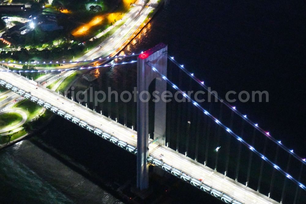 New York at night from the bird perspective: Night lighting River - bridge construction Verrazano-Narrows Bridge Staten Island in New York in United States of America