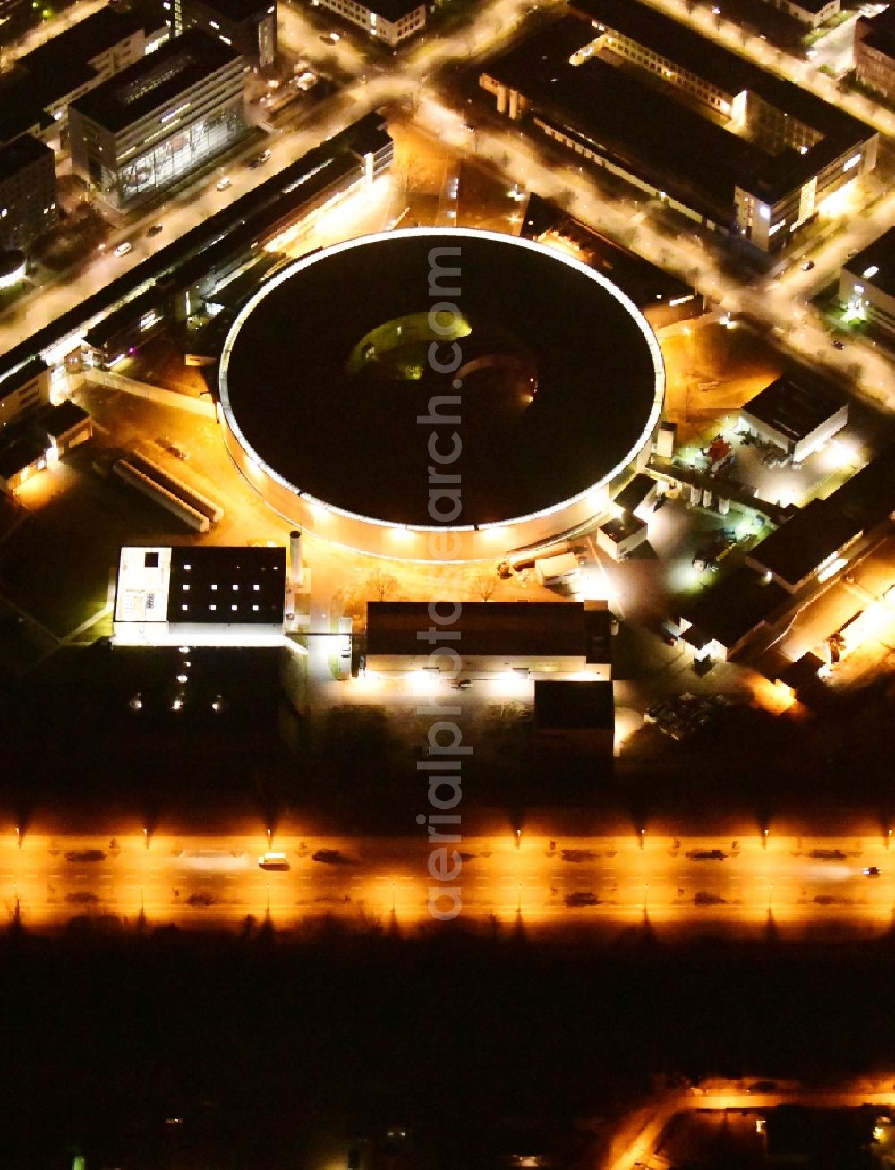 Berlin at night from above - Night lighting research building and office complex Elektronen- Speicherring BESSY - Synchrotronstrahlungsquelle in the district Adlershof in Berlin, Germany