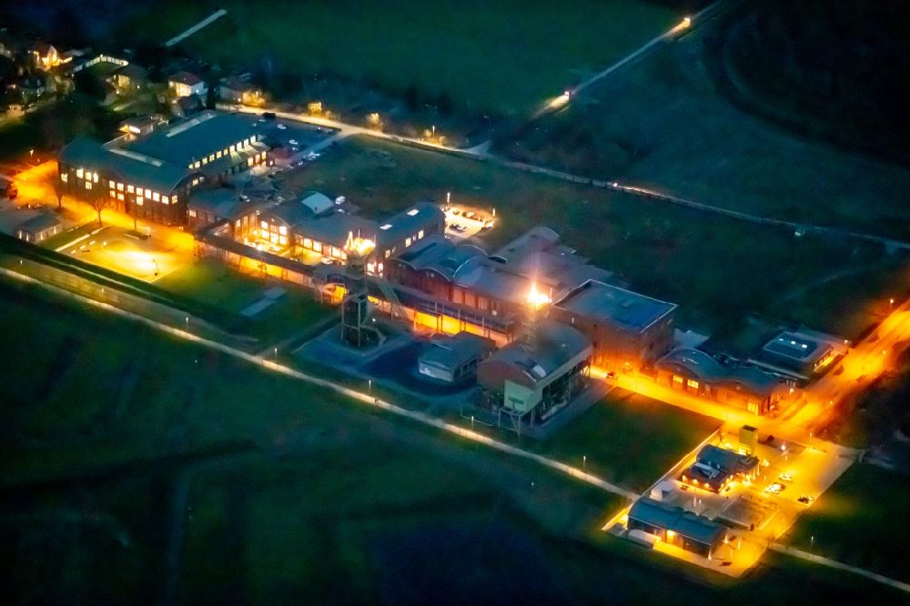 Aerial photograph at night Ahlen - Night lighting on formerly conveyors and mining pits at the headframe Zeche Westfalen in Ahlen in the state North Rhine-Westphalia, Germany