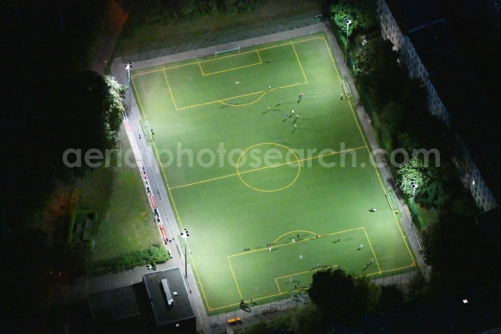 Aerial image at night Berlin - Night lighting sports grounds and football pitch Sportplatz Hauffstrasse in the district Rummelsburg in Berlin, Germany