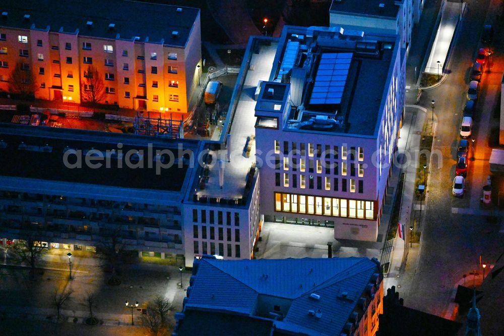 Aerial photograph at night Bernau - Night lighting town Hall building of the city administration Gruenstrasse corner Buergermeisterstrasse in Bernau in the state Brandenburg, Germany