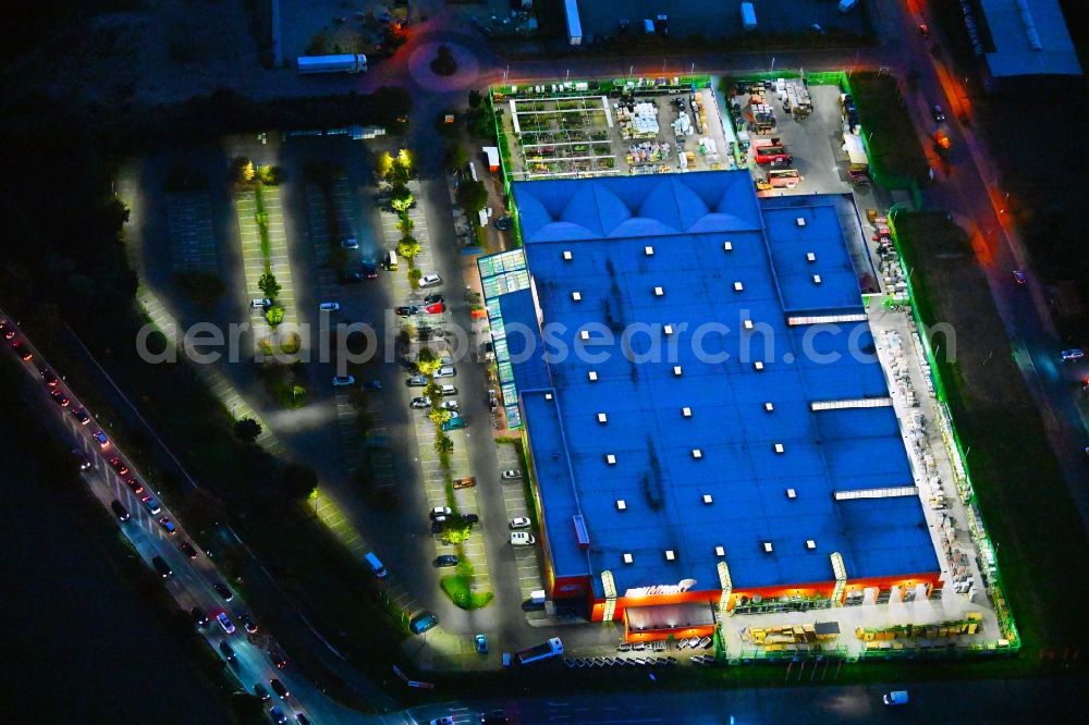 Aerial image at night Lindenberg - Night lighting building of the construction market of Globus Lindenberg in Lindenberg in the state Brandenburg