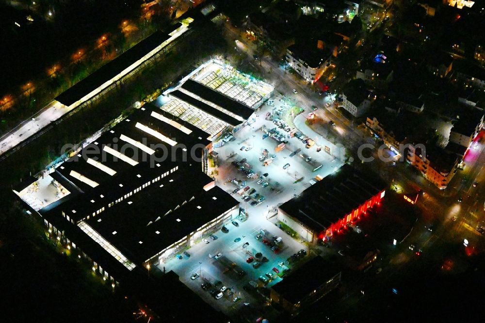 Berlin at night from the bird perspective: Night lighting building of the construction market OBI in the district Reinickendorf in Berlin, Germany