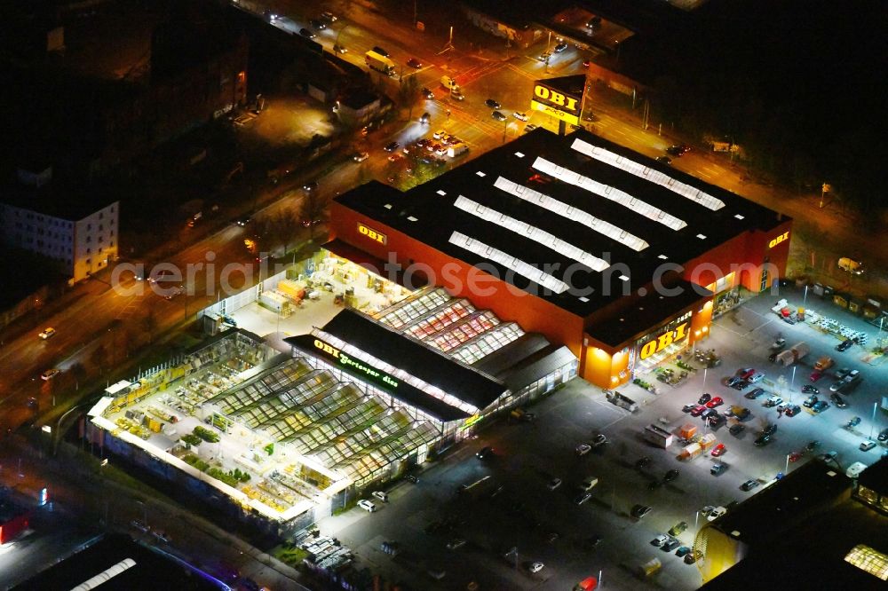 Berlin at night from above - Night lighting Building of the construction market OBI Markt Berlin-Treptow on Adlergestell in the district Adlershof in Berlin, Germany