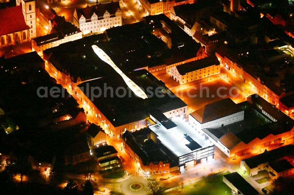 Aerial photograph at night Lutherstadt Wittenberg - Night lighting Building of the shopping center ARSENAL in Lutherstadt Wittenberg in the state Saxony-Anhalt