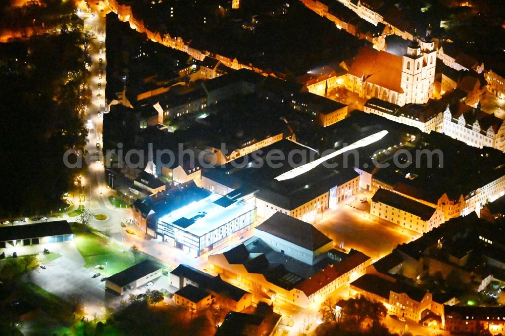 Aerial image at night Lutherstadt Wittenberg - Night lighting Building of the shopping center ARSENAL in Lutherstadt Wittenberg in the state Saxony-Anhalt