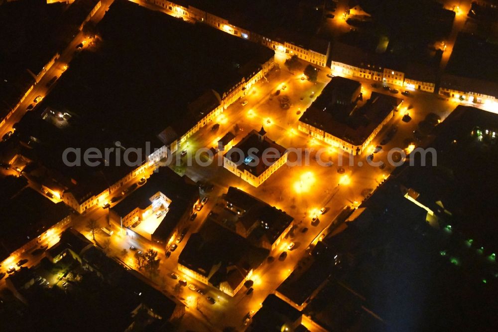 Aerial photograph at night Angermünde - Night lighting Town Hall building of the City Council at the market downtown in Angermuende in the state Brandenburg, Germany