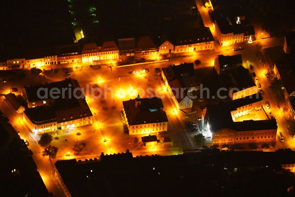 Aerial image at night Angermünde - Night lighting Town Hall building of the City Council at the market downtown in Angermuende in the state Brandenburg, Germany