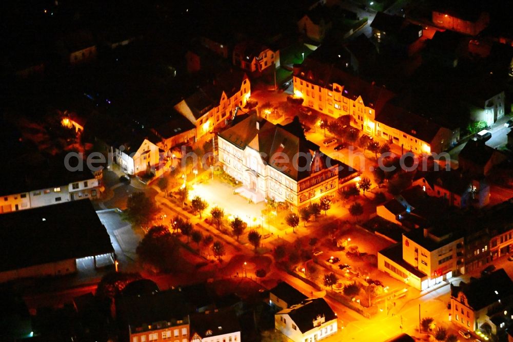 Aerial photograph at night Friedrichsthal - Night lighting town Hall building of the City Council at the market downtown in Friedrichsthal in the state Saarland, Germany