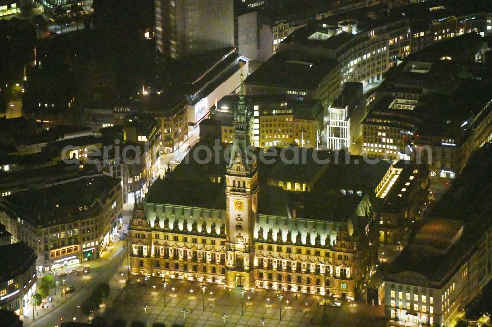 Aerial image at night Hamburg - Night lighting Town Hall building of the City Council at the market downtown in Hamburg, Germany
