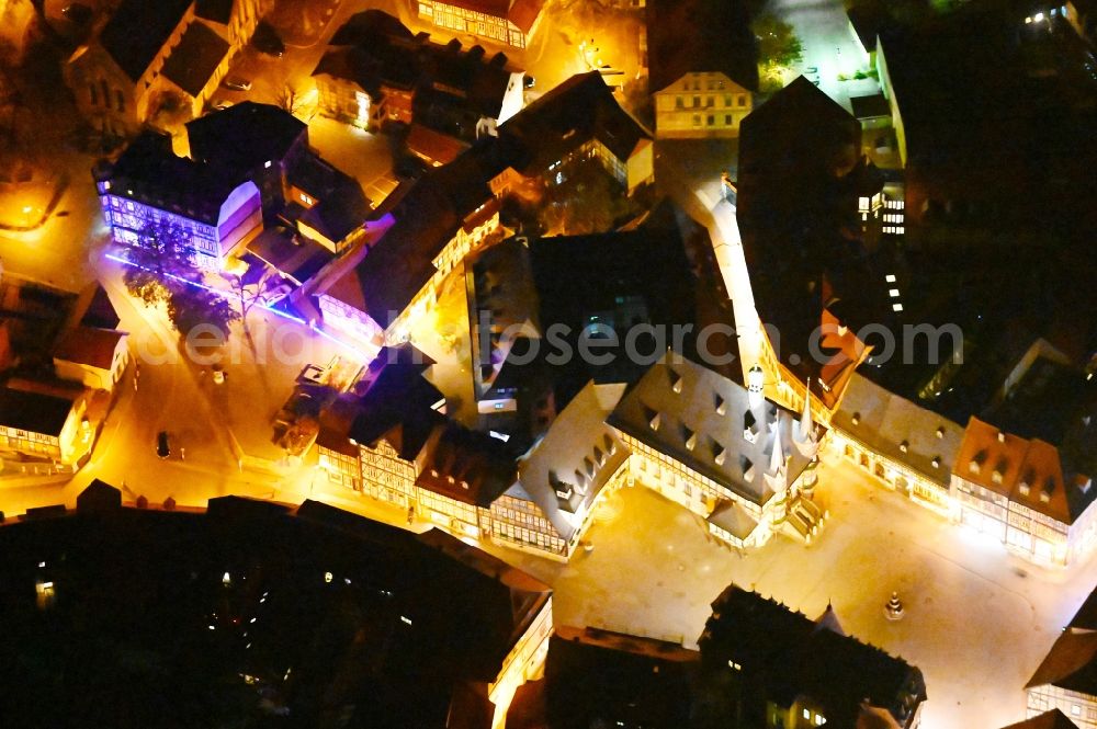 Aerial photograph at night Wernigerode - Night lighting town Hall building of the City Council at the market downtown in Wernigerode in the state Saxony-Anhalt, Germany