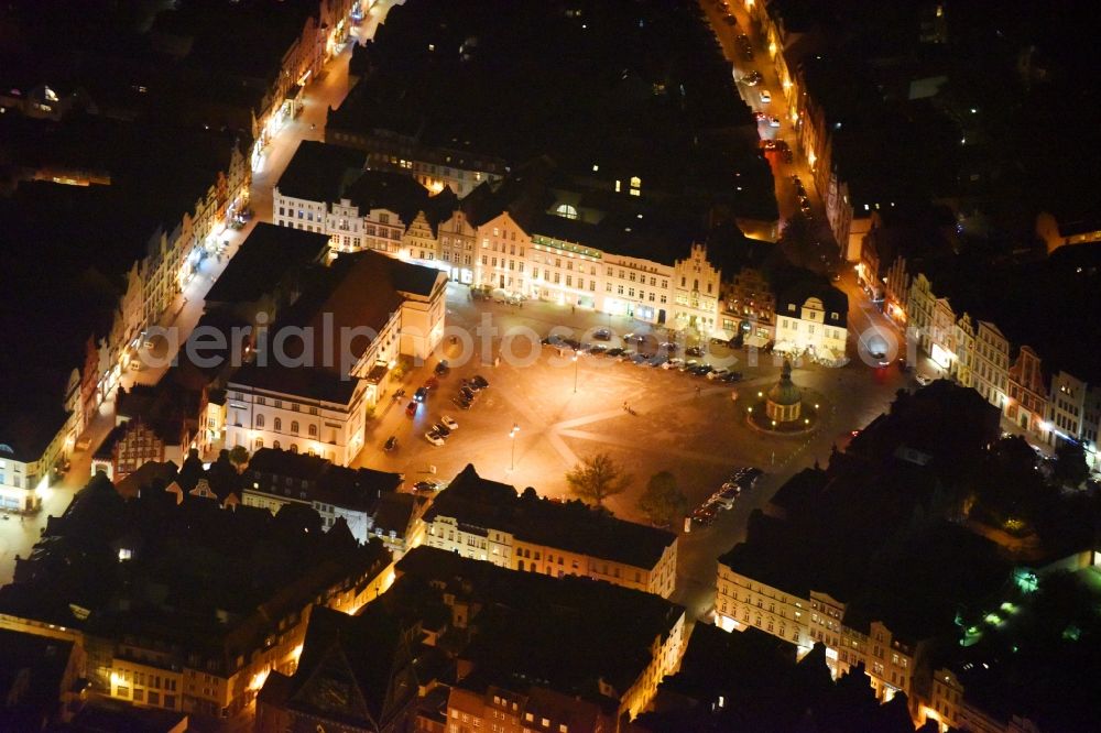 Wismar at night from the bird perspective: Night lighting Town Hall building of the City Council at the market downtown in Wismar in the state Mecklenburg - Western Pomerania, Germany