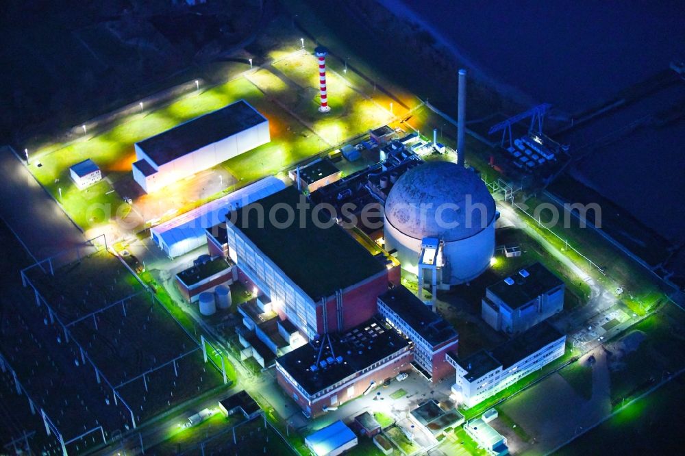 Stade at night from above - Night lighting building the decommissioned reactor units and systems of the NPP - NPP nuclear power plant in Stadersand in the state Lower Saxony