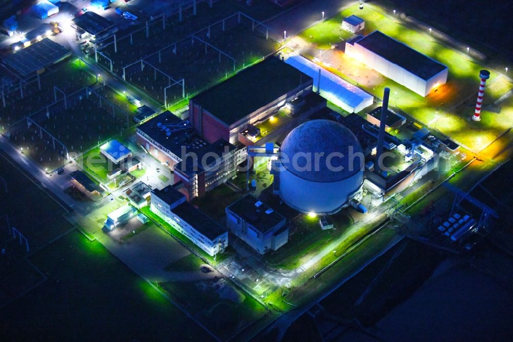 Aerial photograph at night Stade - Night lighting building the decommissioned reactor units and systems of the NPP - NPP nuclear power plant in Stadersand in the state Lower Saxony