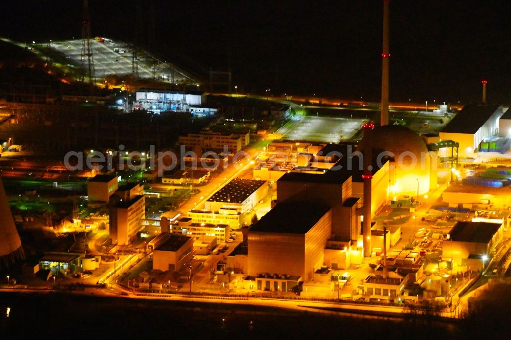 Philippsburg at night from the bird perspective: Night lighting building the partly decommissioned reactor units and systems of the NPP - NPP nuclear power plant EnBW Kernkraft GmbH, Kernkraftwerk Philippsburg in Philippsburg in the state Baden-Wurttemberg, Germany