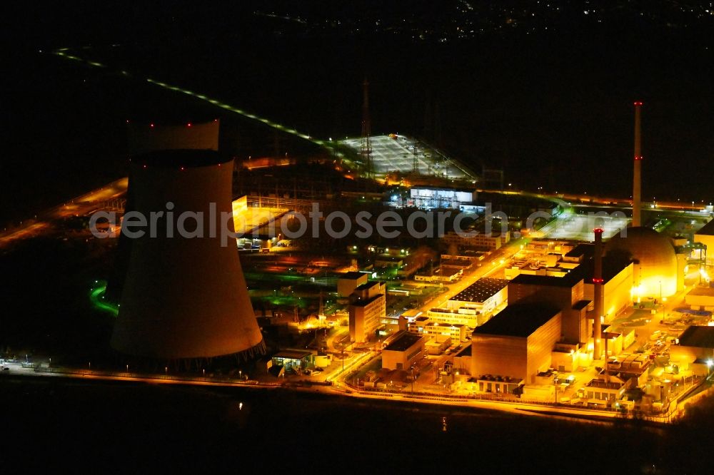 Aerial photograph at night Philippsburg - Night lighting building the partly decommissioned reactor units and systems of the NPP - NPP nuclear power plant EnBW Kernkraft GmbH, Kernkraftwerk Philippsburg in Philippsburg in the state Baden-Wurttemberg, Germany