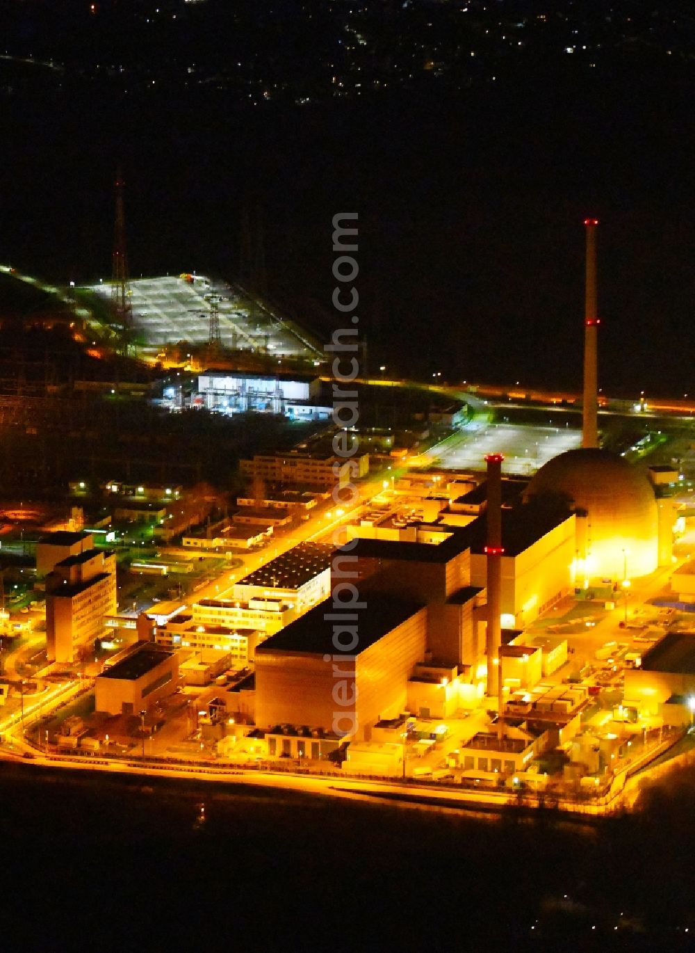 Aerial image at night Philippsburg - Night lighting building the partly decommissioned reactor units and systems of the NPP - NPP nuclear power plant EnBW Kernkraft GmbH, Kernkraftwerk Philippsburg in Philippsburg in the state Baden-Wurttemberg, Germany