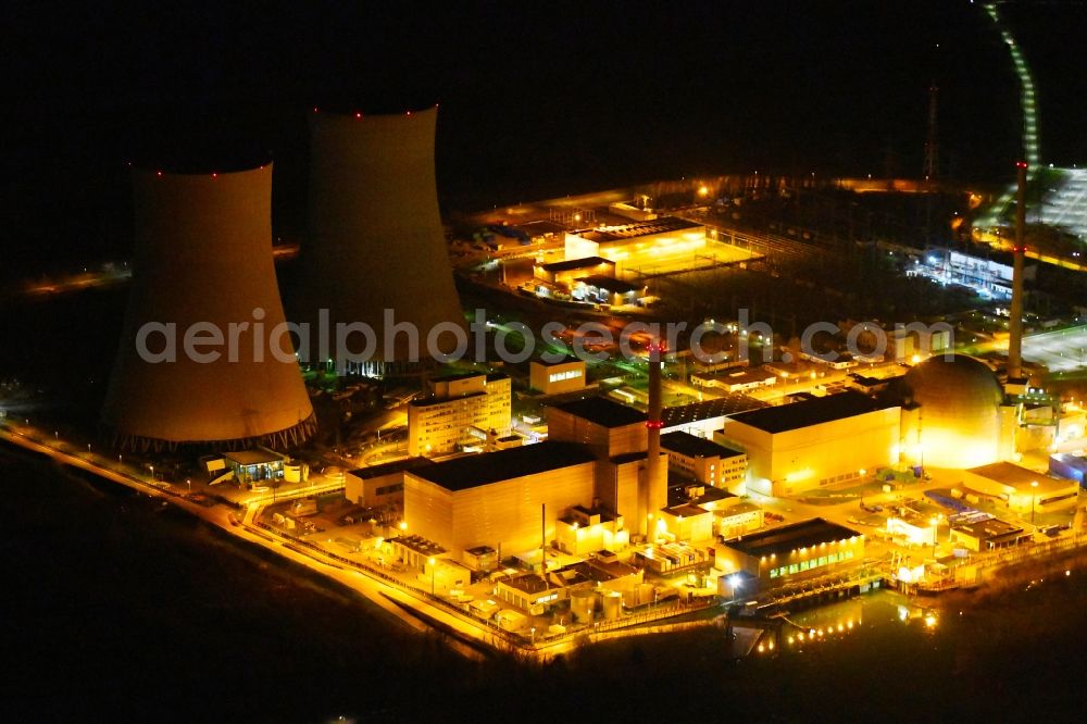 Philippsburg at night from the bird perspective: Night lighting building the partly decommissioned reactor units and systems of the NPP - NPP nuclear power plant EnBW Kernkraft GmbH, Kernkraftwerk Philippsburg in Philippsburg in the state Baden-Wurttemberg, Germany