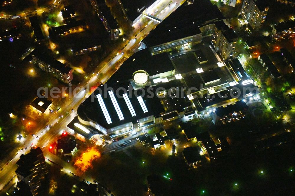 Aerial image at night Berlin - Night lighting Building complex of the shopping mall Gropiuspassagen on Johannisthaler Chaussee in the Gropiusstadt part of the district of Neukoelln in Berlin in Germany