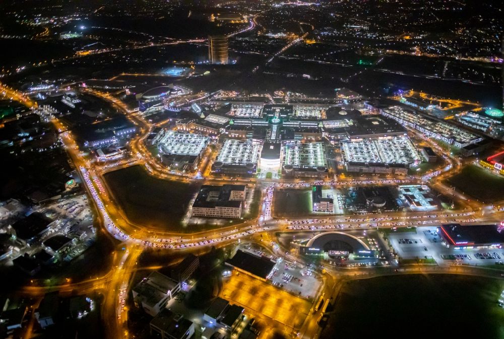 Aerial image at night Oberhausen - Night lighting building complex of the shopping mall Centro in Oberhausen in the state of North Rhine-Westphalia. The mall is the heart of the Neue Mitte part of the city and is located on Osterfelder Strasse