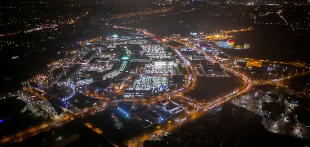 Aerial image at night Oberhausen - Night lighting building complex of the shopping mall Centro in Oberhausen in the state of North Rhine-Westphalia. The mall is the heart of the Neue Mitte part of the city and is located on Osterfelder Strasse