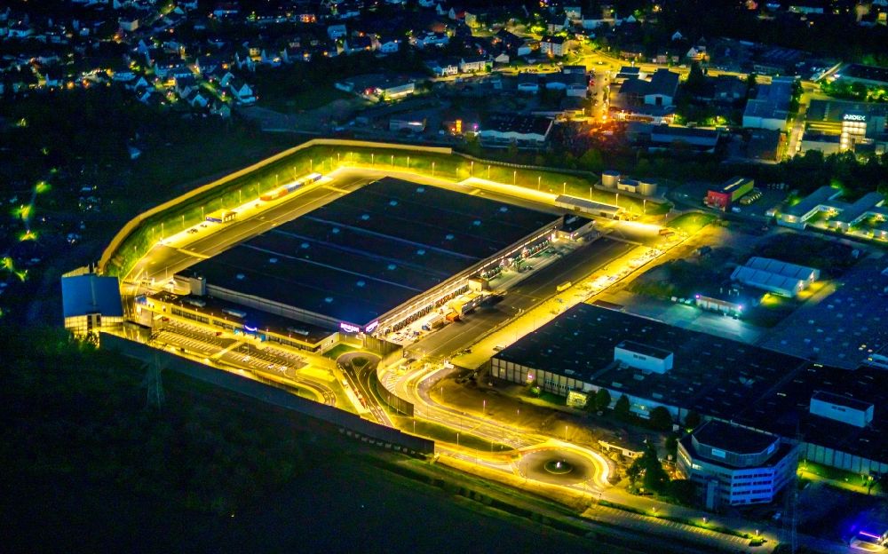 Aerial image at night Witten - Night lighting building complex and grounds of the logistics center with a new Amazon building on Menglinghauser Strasse - Siemensstrasse in the district Ruedinghausen in Witten at Ruhrgebiet in the state North Rhine-Westphalia, Germany