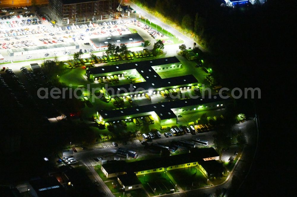 Aerial image at night Berlin - Night lighting building complex and grounds of the logistics center of Deutsche Post AG Alt-Friedrichsfelde in Berlin, Germany