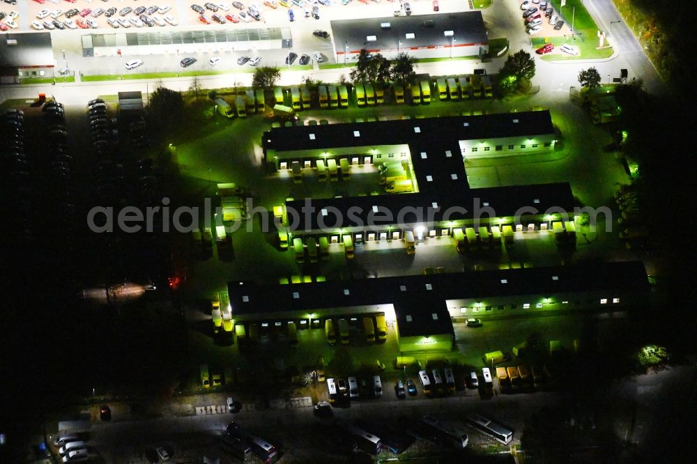 Aerial photograph at night Berlin - Night lighting building complex and grounds of the logistics center of Deutsche Post AG Alt-Friedrichsfelde in Berlin, Germany