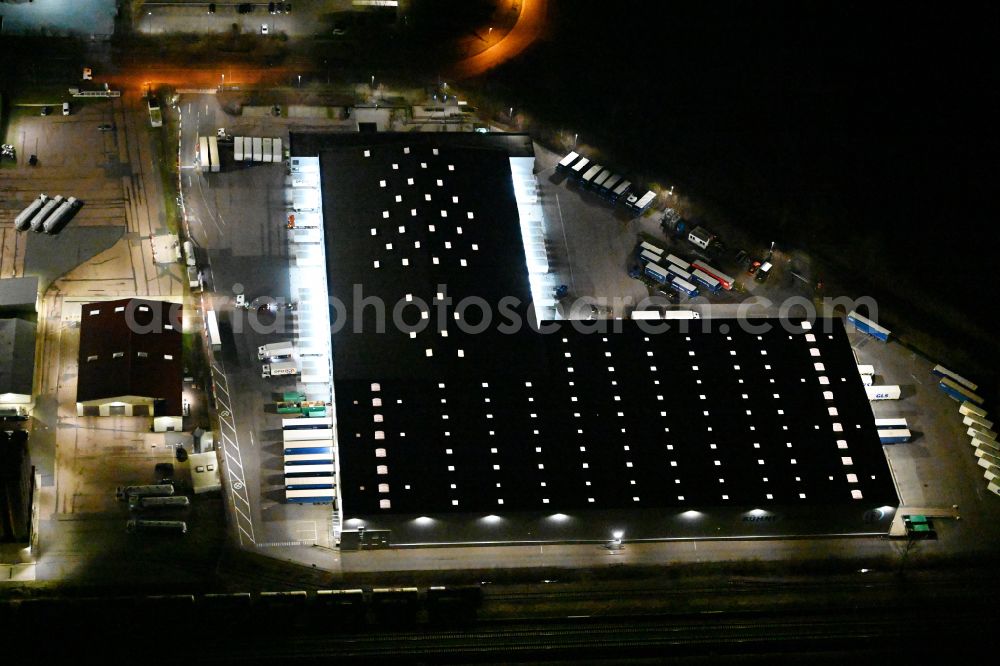 Markranstädt at night from above - Night lighting building complex and grounds of the logistics center of Kuehne + Nagel (AG & Co.) KG Am Glaeschen in Markranstaedt in the state Saxony, Germany