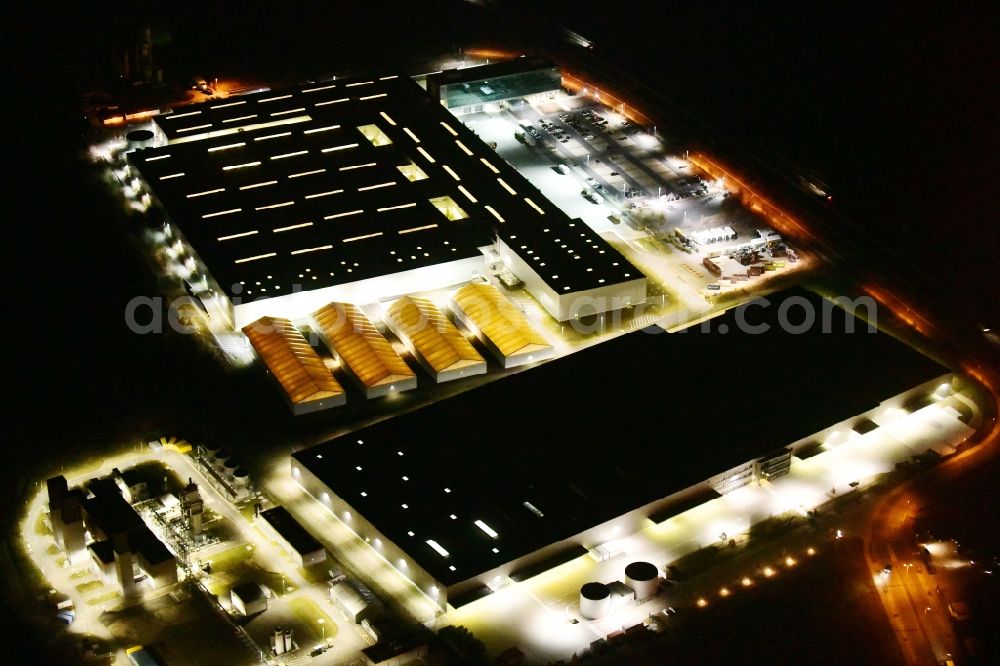 Ludwigsfelde at night from above - Night lighting building complex and grounds of the logistics center of Volkswagen Original Teile Logistik GmbH & Co. KG (OTLG) in Ludwigsfelde in the state Brandenburg, Germany
