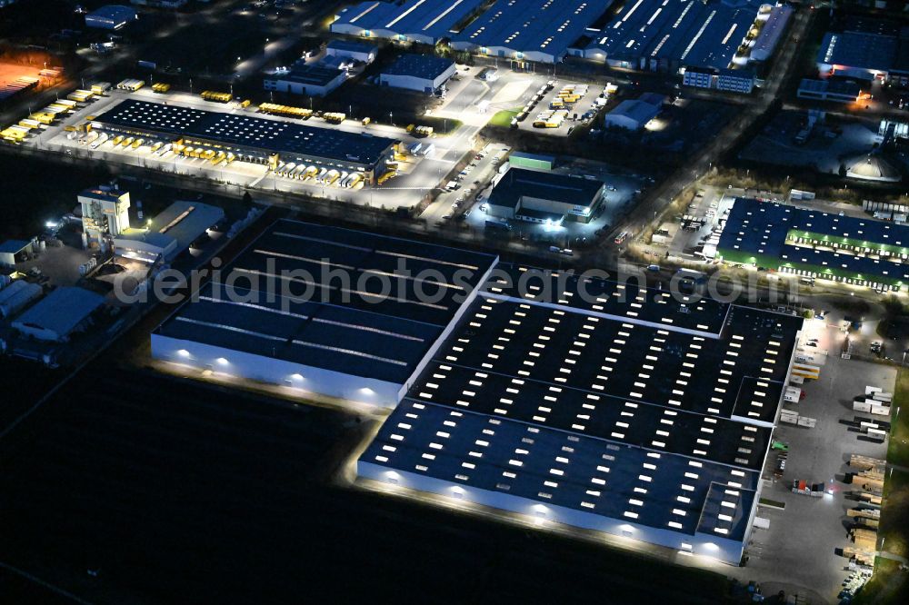 Aerial image at night Thörey - Night lighting building complex and distribution center on the site of Carpenter GmbH on street Industriestrasse in Thoerey in the state Thuringia, Germany