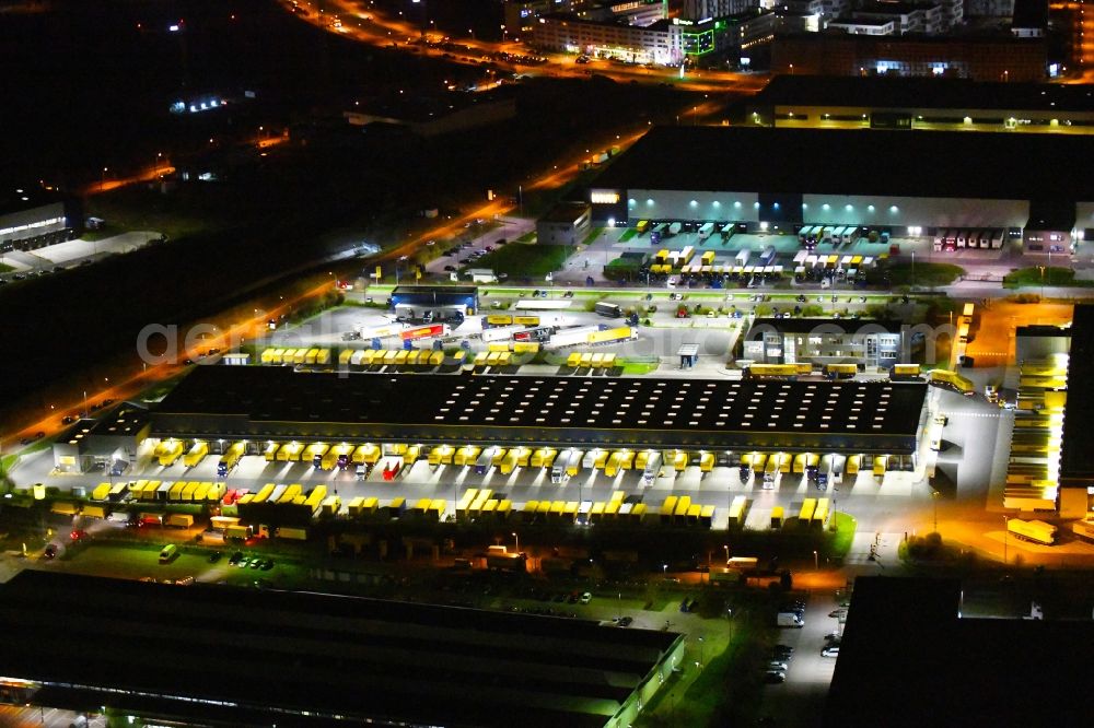 Schönefeld at night from above - Night lighting building complex and distribution center on the site of DACHSER SE An den Gehren in Schoenefeld in the state Brandenburg, Germany