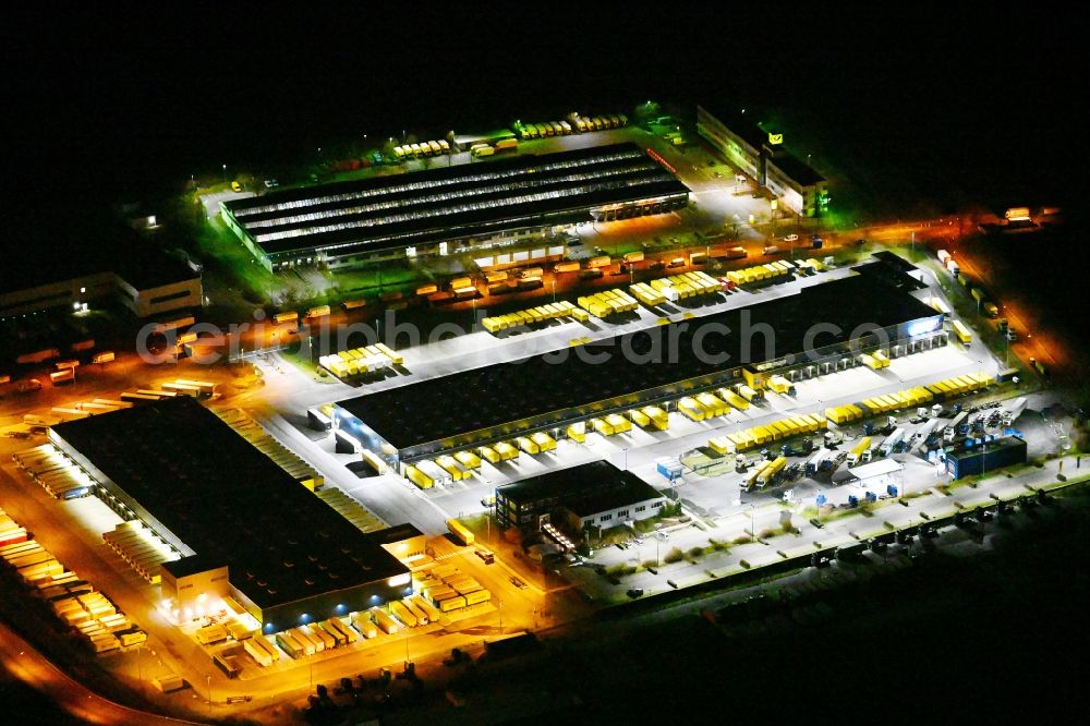 Aerial image at night Schönefeld - Night lighting building complex and distribution center on the site of DACHSER SE An den Gehren in Schoenefeld in the state Brandenburg, Germany