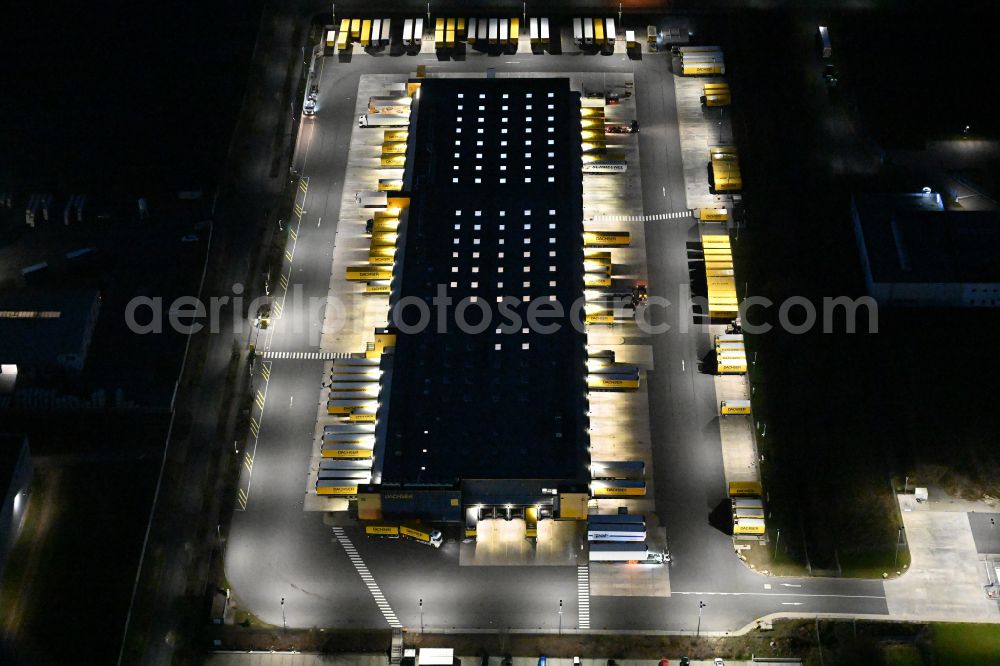 Aerial photograph at night Thörey - Night lighting building complex and distribution center on the site of DACHSER SE in Thoerey in the state Thuringia, Germany