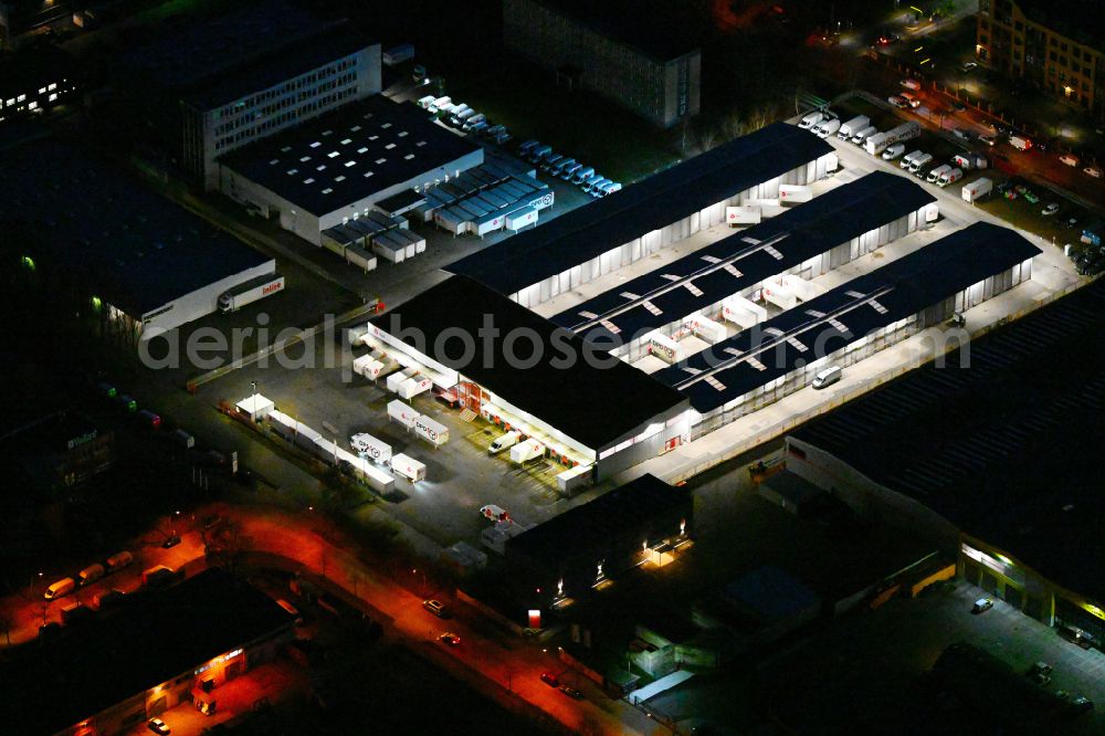 Berlin at night from above - Night lighting building complex and distribution center on the site of DPD Deuter Paketdienst in the district Hohenschoenhausen in Berlin, Germany