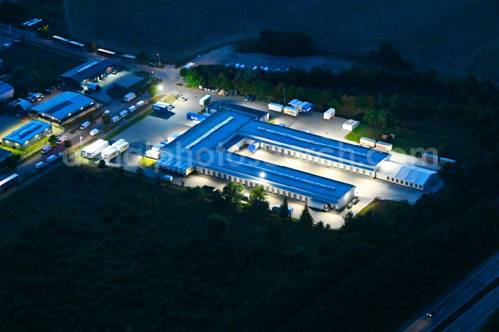 Aerial image at night Bernau - Night lighting building complex and distribution center on the site GLS on Ringstrasse in the district Schoenow in Bernau in the state Brandenburg, Germany