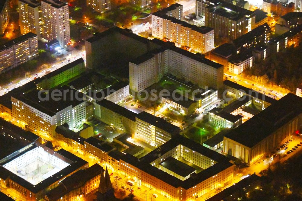 Aerial image at night Berlin - Night lighting Building complex of the Memorial of the former Stasi Ministry for State Security of the GDR in the Ruschestrasse in Berlin Lichtenberg