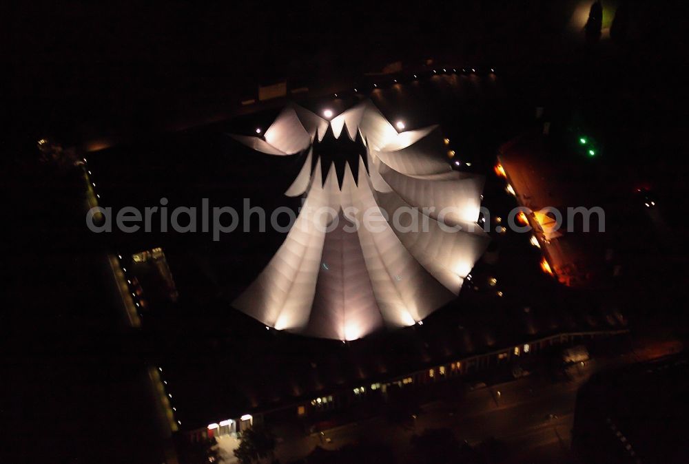 Aerial photograph at night Berlin - Night lighting event and music-concert grounds of the Arena Tempodrom on Moeckernstrasse in the district Kreuzberg in Berlin, Germany