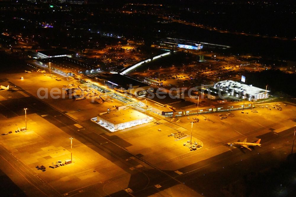 Aerial image at night Schönefeld - Night lighting Runway with hangar taxiways and terminals on the grounds of the airport Berlin-Schoenefeld in Schoenefeld in the state Brandenburg, Germany