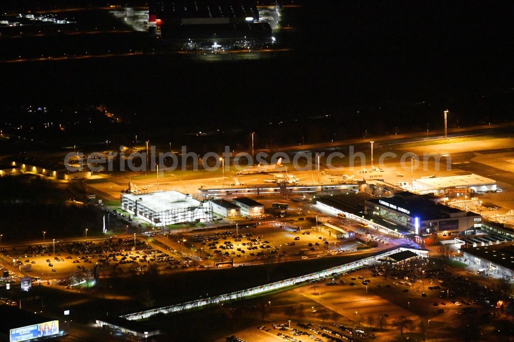 Aerial image at night Schönefeld - Night lighting Runway with hangar taxiways and terminals on the grounds of the airport Berlin-Schoenefeld in Schoenefeld in the state Brandenburg, Germany