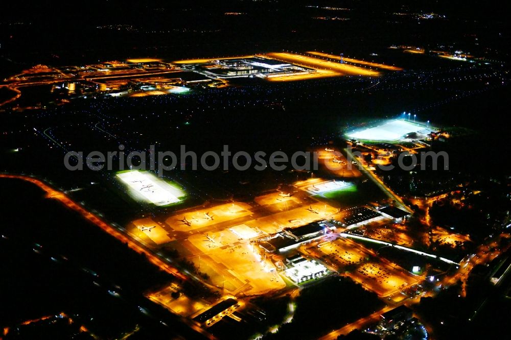 Schönefeld at night from above - Night lighting Runway with hangar taxiways and terminals on the grounds of the airport Berlin-Schoenefeld in Schoenefeld in the state Brandenburg, Germany